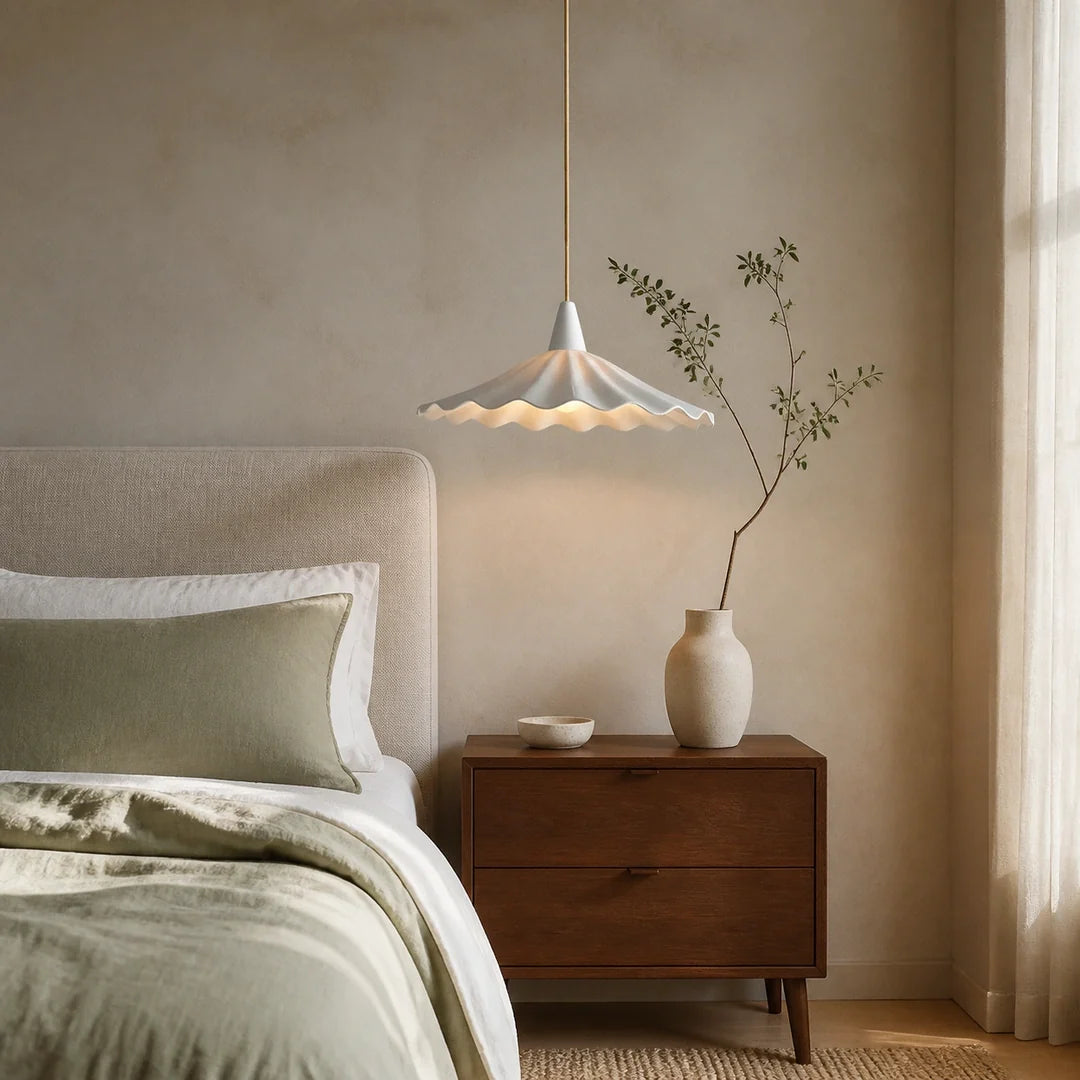 Luminária pendente de cerâmica branca ao lado da cama em quarto minimalista