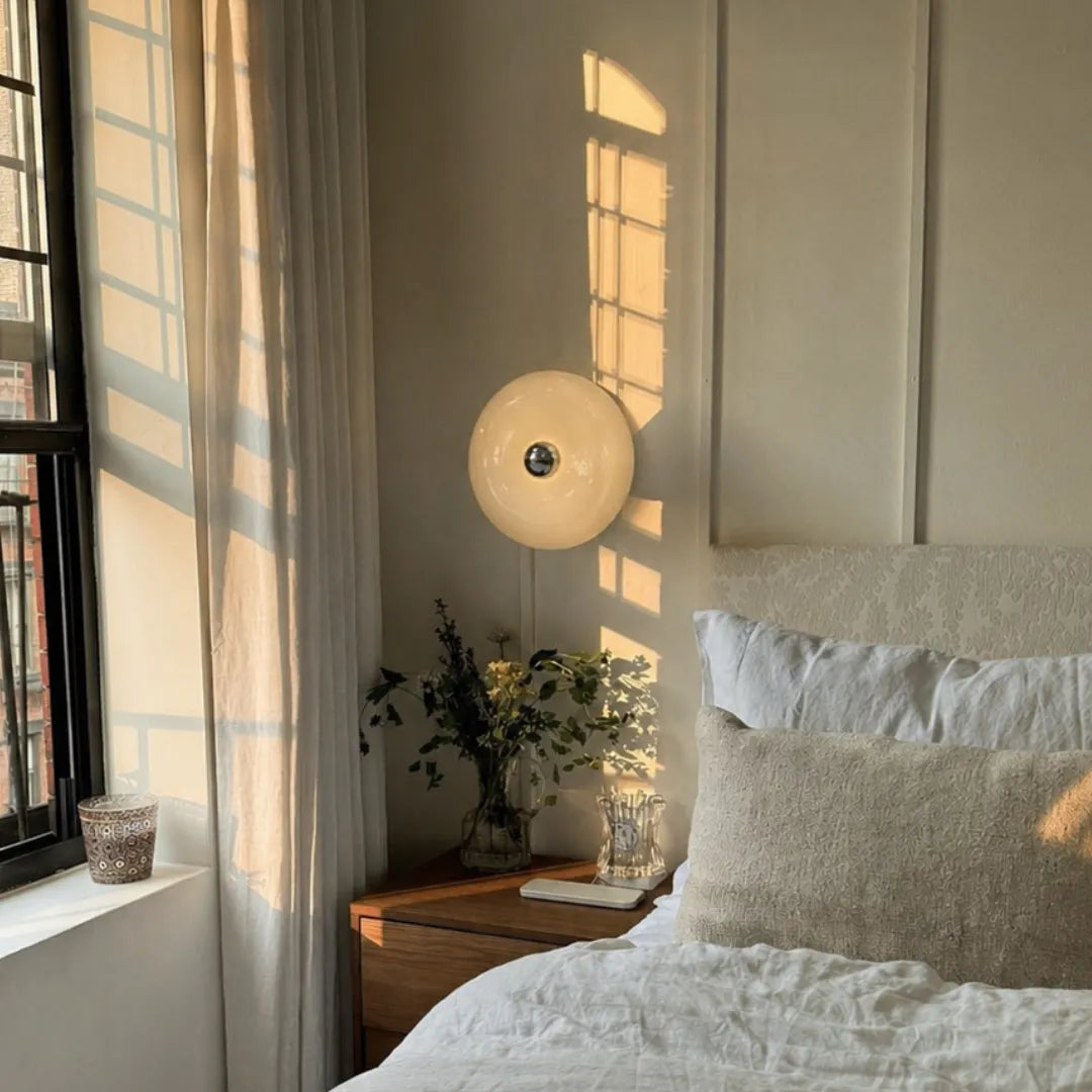 Arandela donut em parede de quarto com cabeceira branca, planta e luz natural — Arandela de Parede LED Vidro Donut Laranja Touch Tricolor — Tonzi